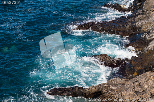 Image of beautiful view on blue ocean water and rocky coast line