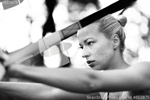 Image of Training with fitness straps outdoors.