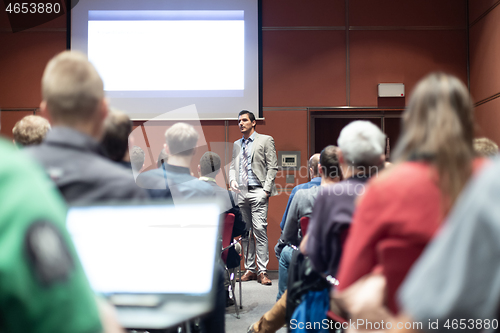 Image of Business speaker giving a talk at business conference meeting event.