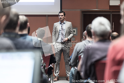 Image of Business speaker giving a talk at business conference meeting event.