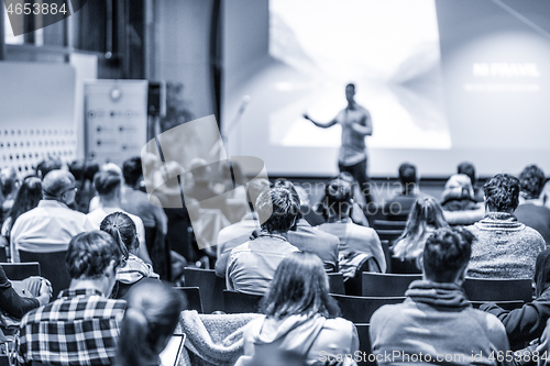 Image of Male public peaker giving presentation on business conference event.