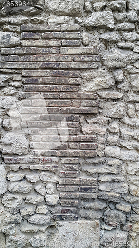 Image of Rough very old wall with bricks and cobblestones