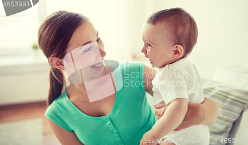 Image of happy young mother with little baby at home