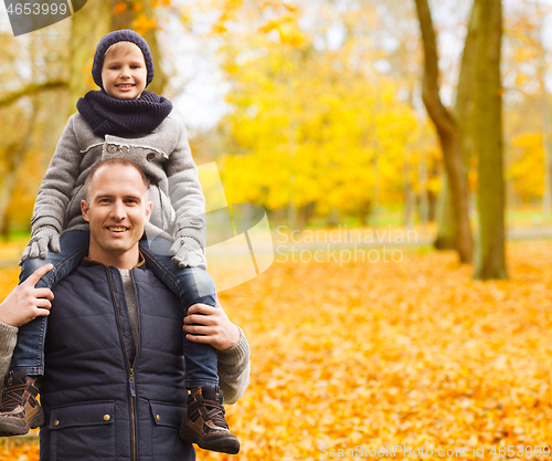 Image of happy family having fun in autumn park