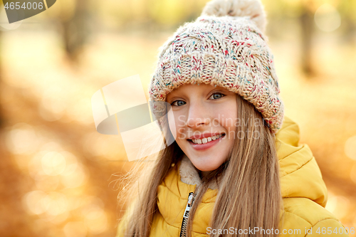 Image of portrait of happy girl at autumn park
