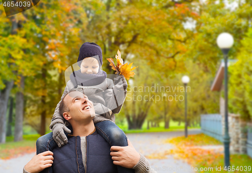 Image of happy family having fun in autumn park