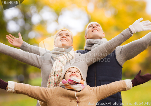 Image of happy family having fun in autumn park