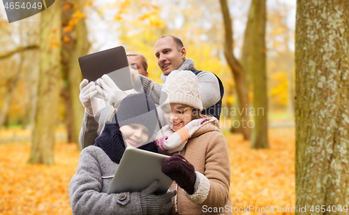 Image of happy family with tablet pc in autumn park