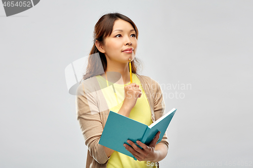 Image of asian student woman with diary and pencil