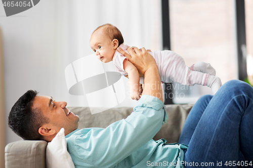 Image of happy middle aged father with baby at home