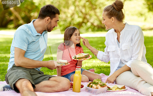 Image of happy family having picnic at summer park