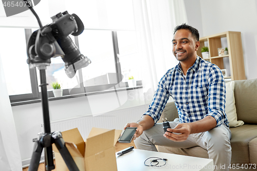 Image of male blogger with smartphone videoblogging