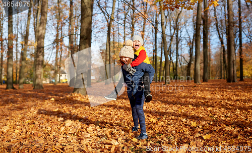 Image of happy children having fun at autumn park