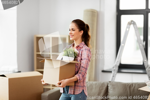 Image of happy woman with stuff moving to new home