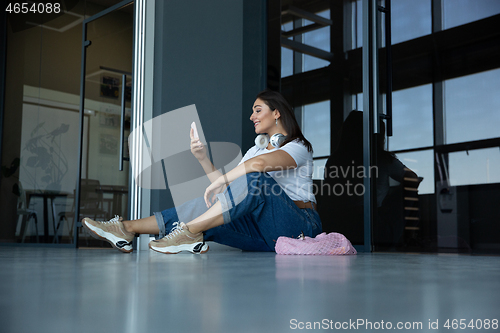 Image of Young woman waiting for departure in airport, traveler with small baggage, influencer\'s lifestyle