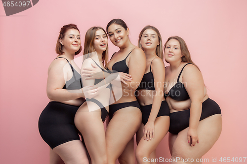 Image of Portrait of beautiful young women with different shapes posing on pink background