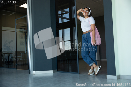 Image of Young woman waiting for departure in airport, traveler with small baggage, influencer\'s lifestyle