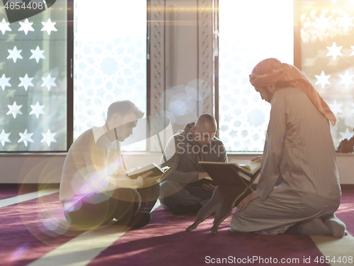 Image of muslim people in mosque reading quran together