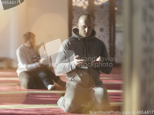 Image of muslim people praying in mosque