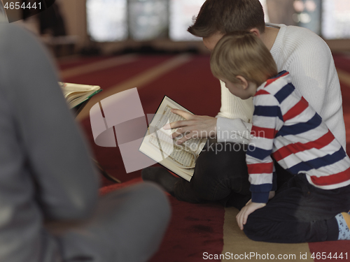 Image of muslim people in mosque reading quran together