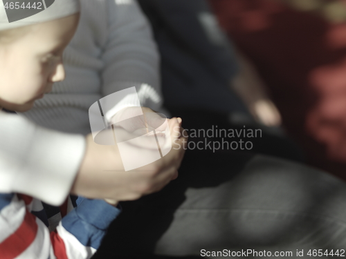 Image of father and son in mosque praying and reading holly book quran to