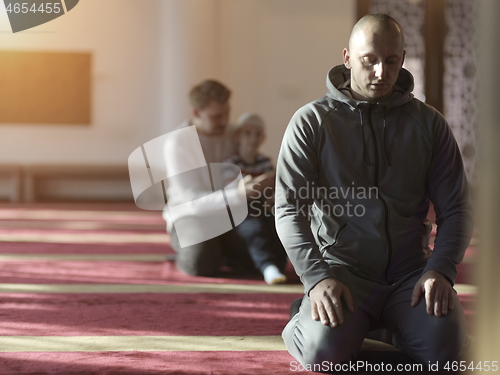 Image of muslim people praying in mosque