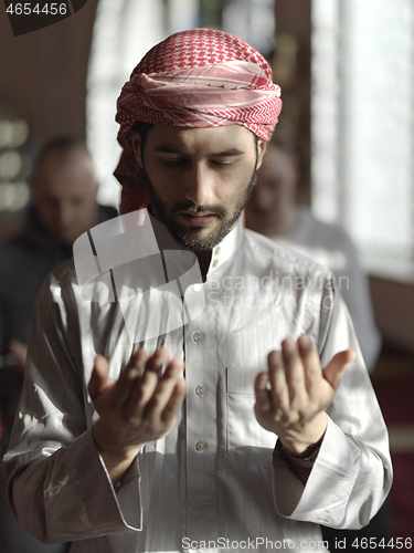 Image of muslim people praying in mosque