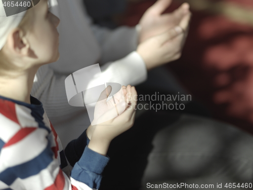 Image of father and son in mosque praying