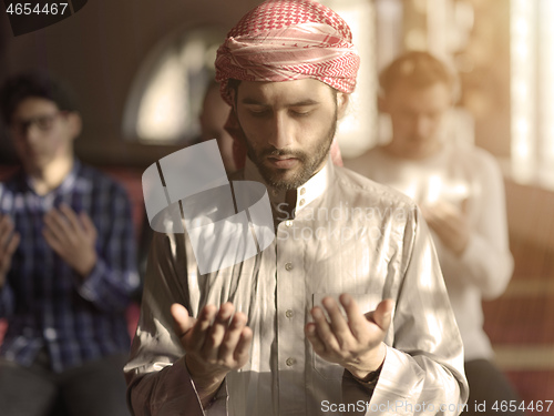 Image of muslim people praying in mosque