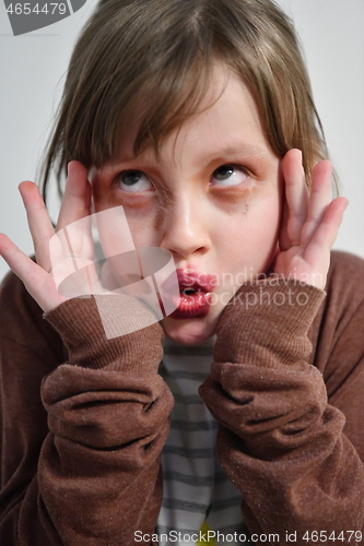 Image of Little girl playing with mommy\'s make up