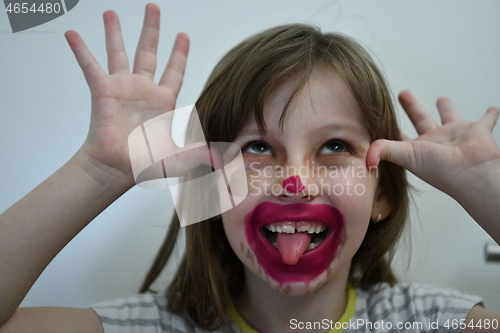 Image of Little girl playing with mommy\'s make up