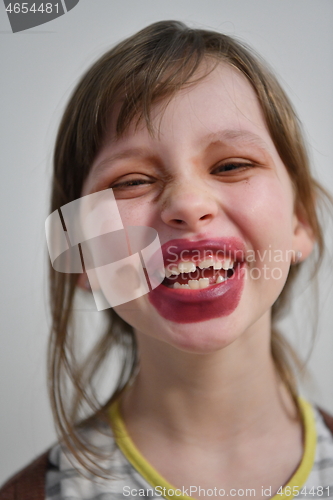 Image of Little girl playing with mommy\'s make up