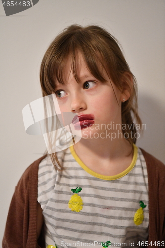 Image of Little girl playing with mommy\'s make up