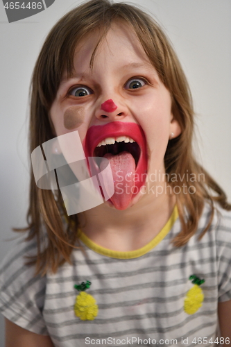 Image of Little girl playing with mommy\'s make up