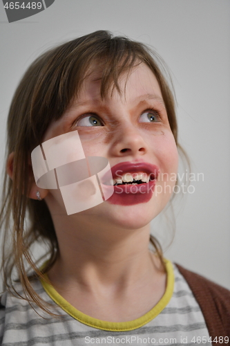 Image of Little girl playing with mommy\'s make up