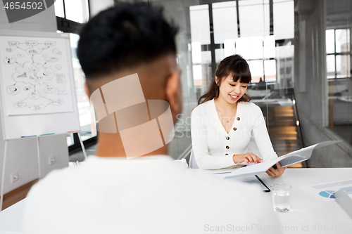 Image of employer having interview with employee at office