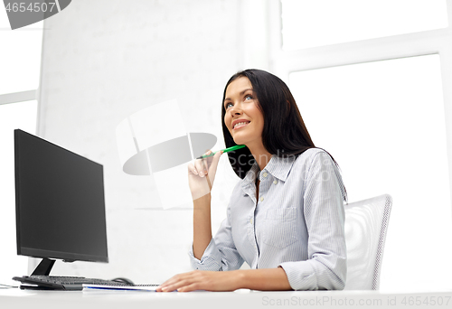 Image of businesswoman writing to notebook at office