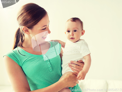 Image of happy young mother with little baby at home