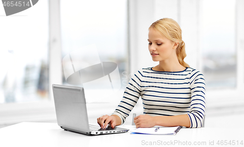 Image of student woman with laptop and notebook