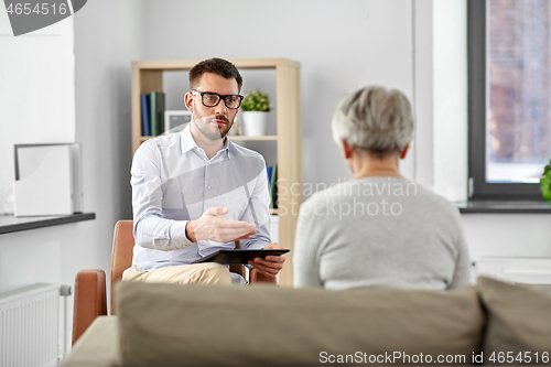 Image of psychologist talking to senior woman patient
