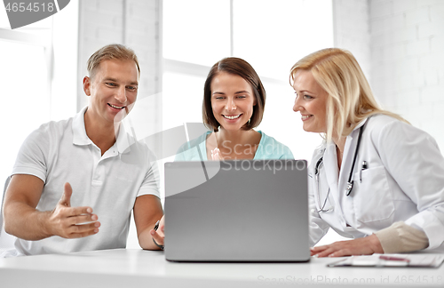 Image of couple visiting doctor at family planning clinic