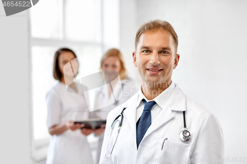 Image of smiling doctor in white coat at hospital