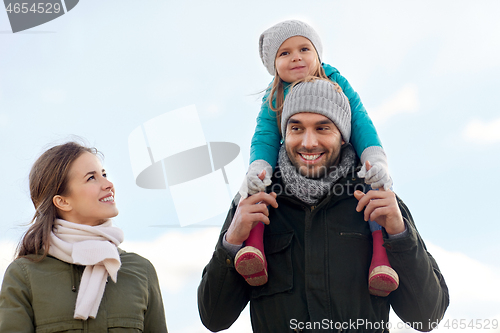 Image of happy family walking in autumn