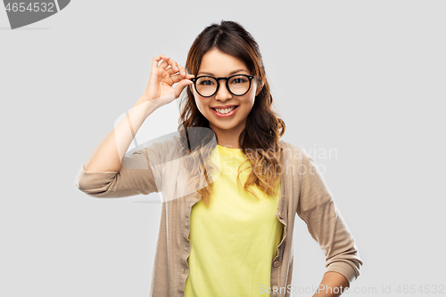 Image of happy asian woman in glasses or student