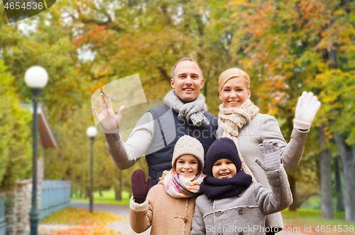 Image of happy family in autumn park