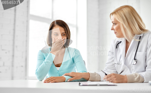 Image of doctor and sad woman patient at hospital