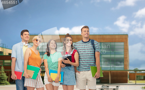 Image of students with notebooks, books and folders