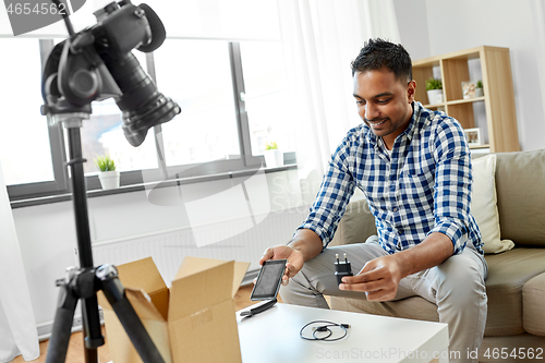 Image of male blogger with smartphone videoblogging