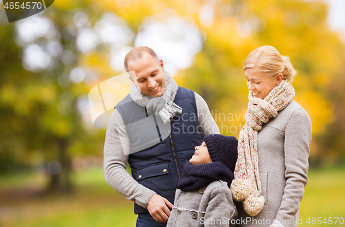 Image of happy family in autumn park