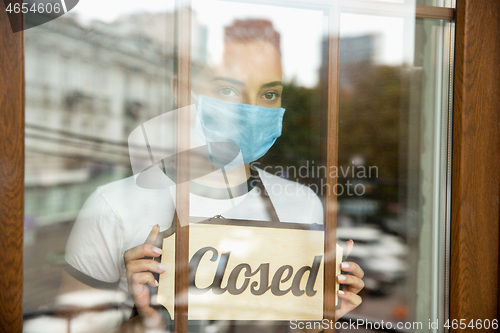 Image of Closed sign on the glass of street cafe or restaurant